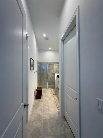 a view of a hallway with bathroom