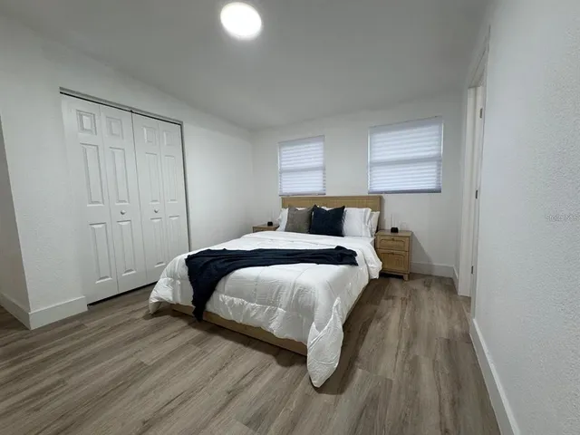 a bedroom with a bed and a night stand