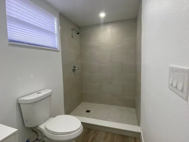 a white toilet sitting next to a bathroom sink