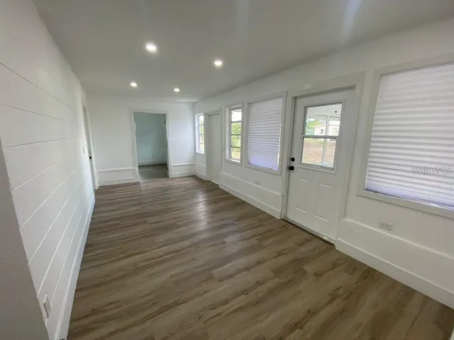 wooden floor in an empty room with a window