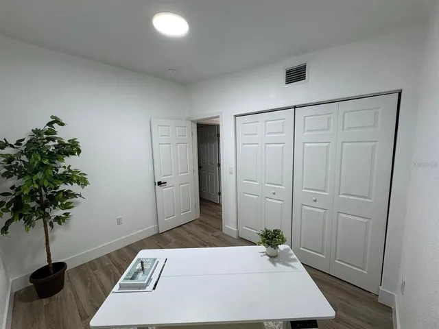 a view of an entryway with wooden floor