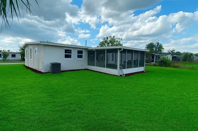 a view of a house with backyard and garden