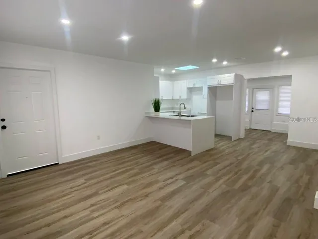 a view of a kitchen with a sink and a stove top oven