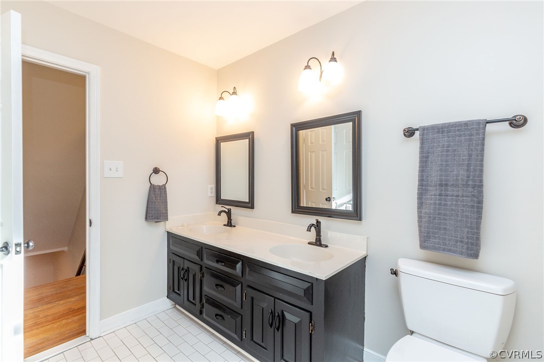 14301 Huntgate Woods Road Midlothian, VA 23112 - Photo 24 of 34 a bathroom with double vanity sink a toilet and a mirror
