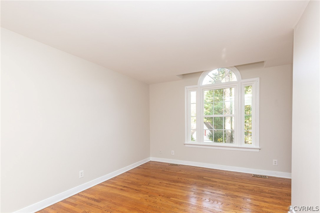 14301 Huntgate Woods Road Midlothian, VA 23112 - Photo 25 of 34 an empty room with wooden floor and windows