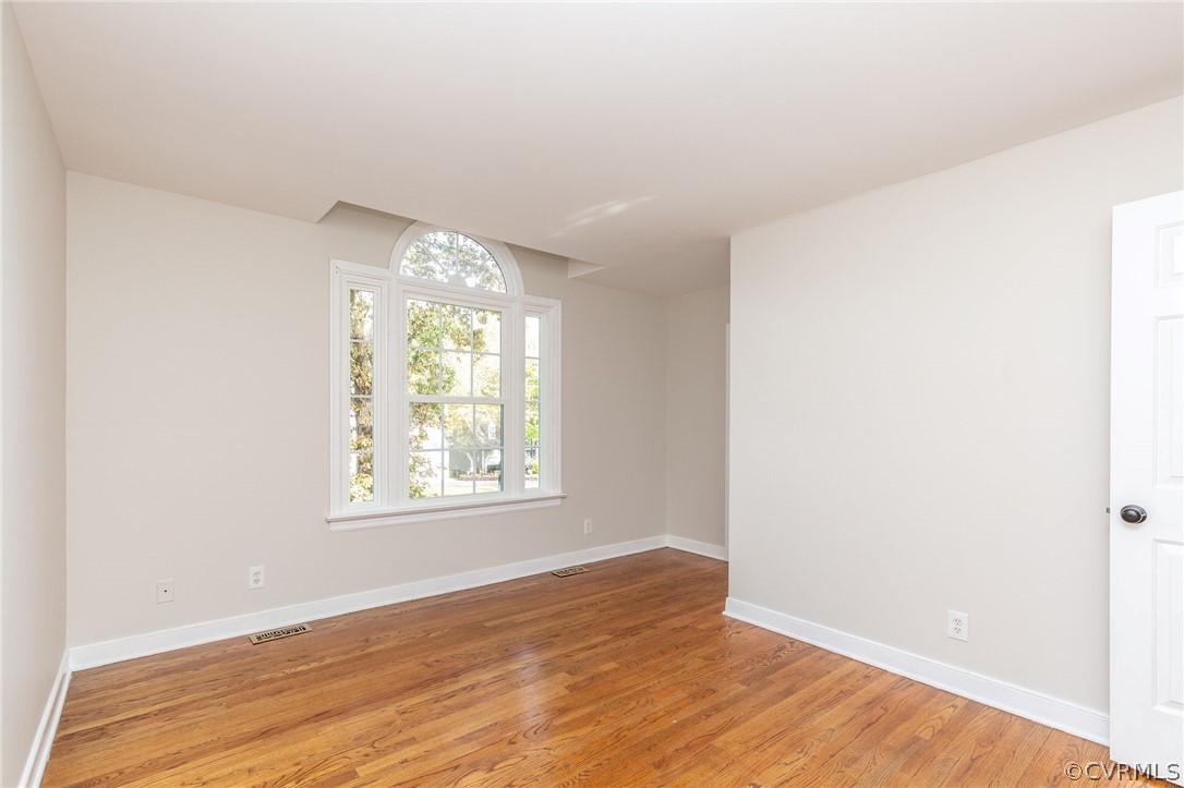 14301 Huntgate Woods Road Midlothian, VA 23112 - Photo 26 of 34 an empty room with wooden floor and windows