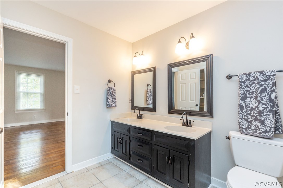 14301 Huntgate Woods Road Midlothian, VA 23112 - Photo 4 of 34 a bathroom with a double vanity sink mirror and toilet