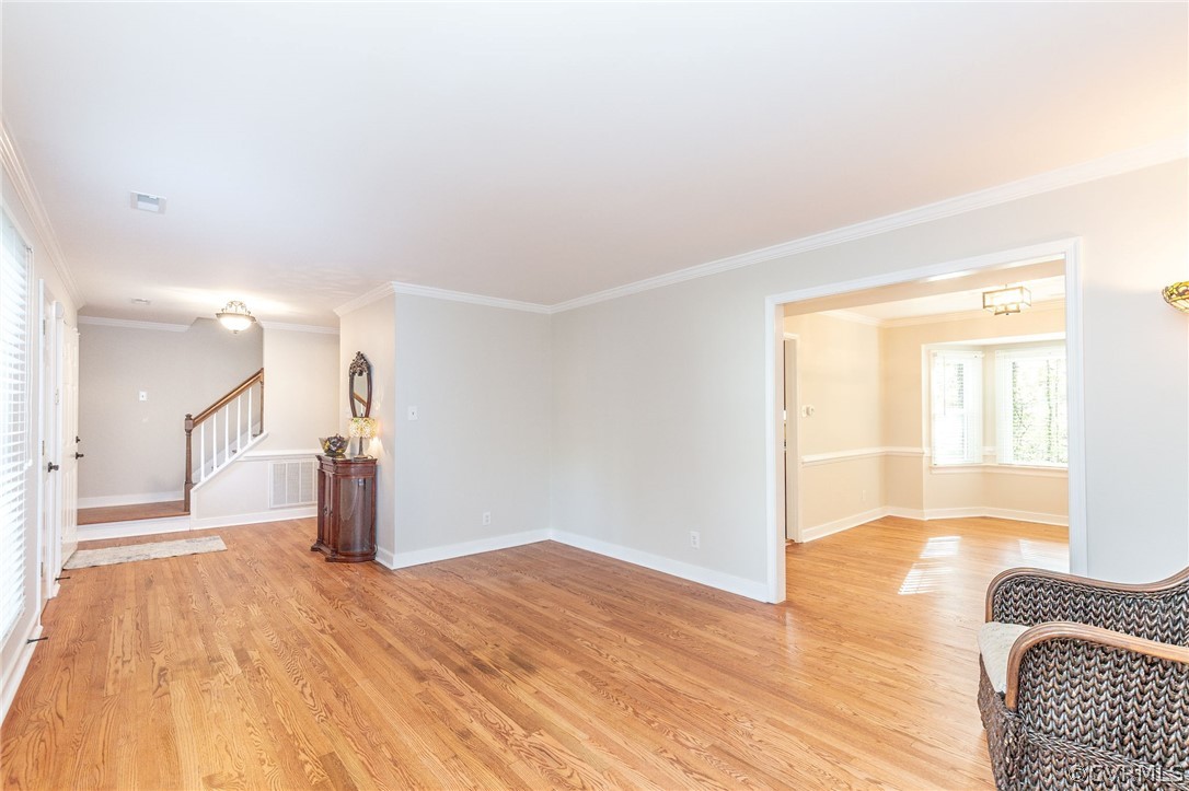 14301 Huntgate Woods Road Midlothian, VA 23112 - Photo 6 of 34 a view of a livingroom with wooden floor and a rug