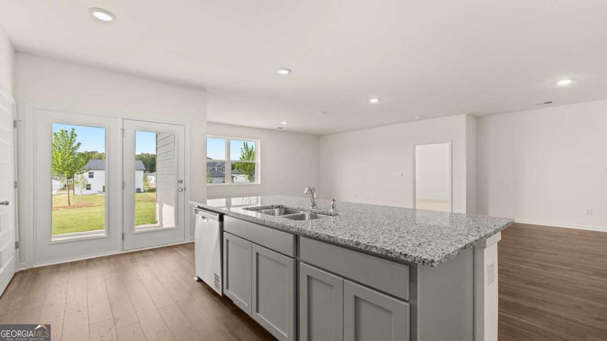 8576 Seabiscuit Road Lithonia, GA 30058 - Photo 11 of 22 a kitchen with a sink and wooden floor