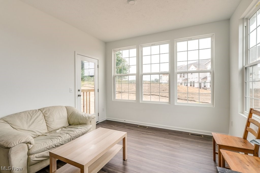 765 River Run Road Aurora, OH 44202 - Photo 13 of 35 Living room featuring hardwood / wood-style floors and a healthy amount of sunlight