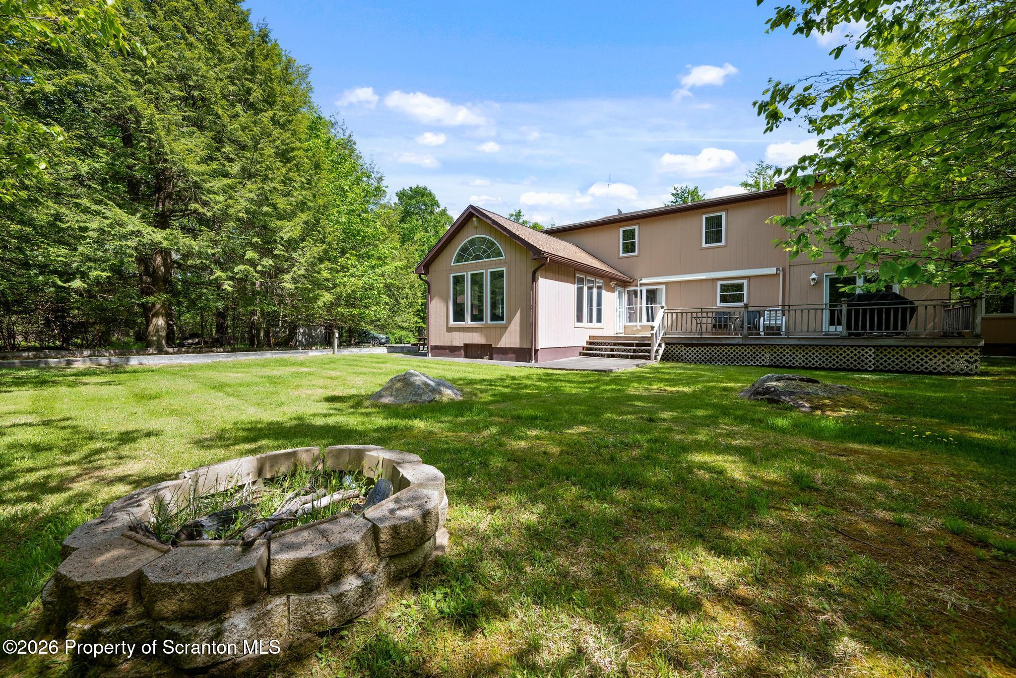 58 Bender Road Gouldsboro, PA 18424 - Photo 51 of 55 a view of a house with a big yard potted plants and large tree