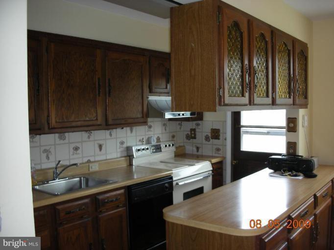 3443 Dunran Road Dundalk, MD 21222 - Photo 11 of 29 a kitchen with a sink and cabinets
