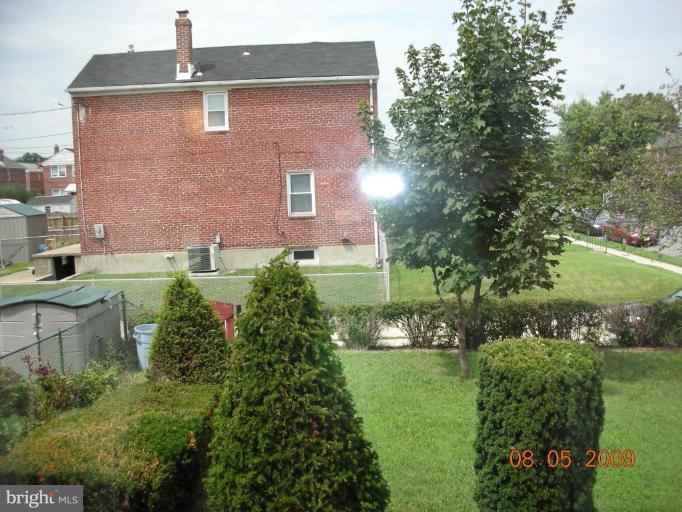3443 Dunran Road Dundalk, MD 21222 - Photo 13 of 29 a backyard of a house with lots of green space and lake view