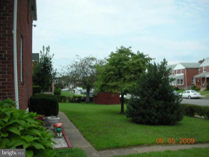 3443 Dunran Road Dundalk, MD 21222 - Photo 17 of 29 a view of a garden with plants and a bench