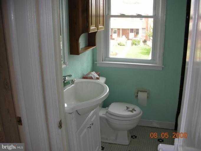 3443 Dunran Road Dundalk, MD 21222 - Photo 4 of 29 a bathroom with a sink toilet and a window