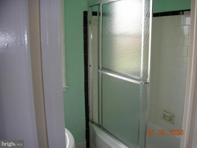 3443 Dunran Road Dundalk, MD 21222 - Photo 5 of 29 a bathroom with a glass shower door