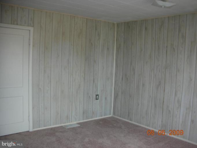 3443 Dunran Road Dundalk, MD 21222 - Photo 7 of 29 a view of an empty room with wooden wall