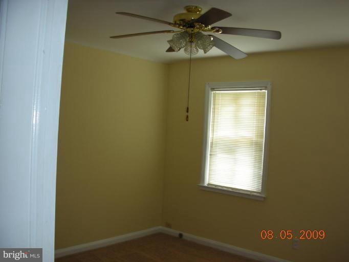 3443 Dunran Road Dundalk, MD 21222 - Photo 8 of 29 an empty room with a window and a fan