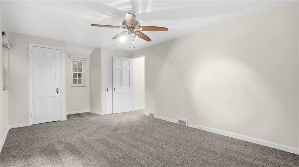 2339 Collins Road Pittsburgh, PA 15235 - Photo 21 of 24 an empty room with a chandelier fan and closet area