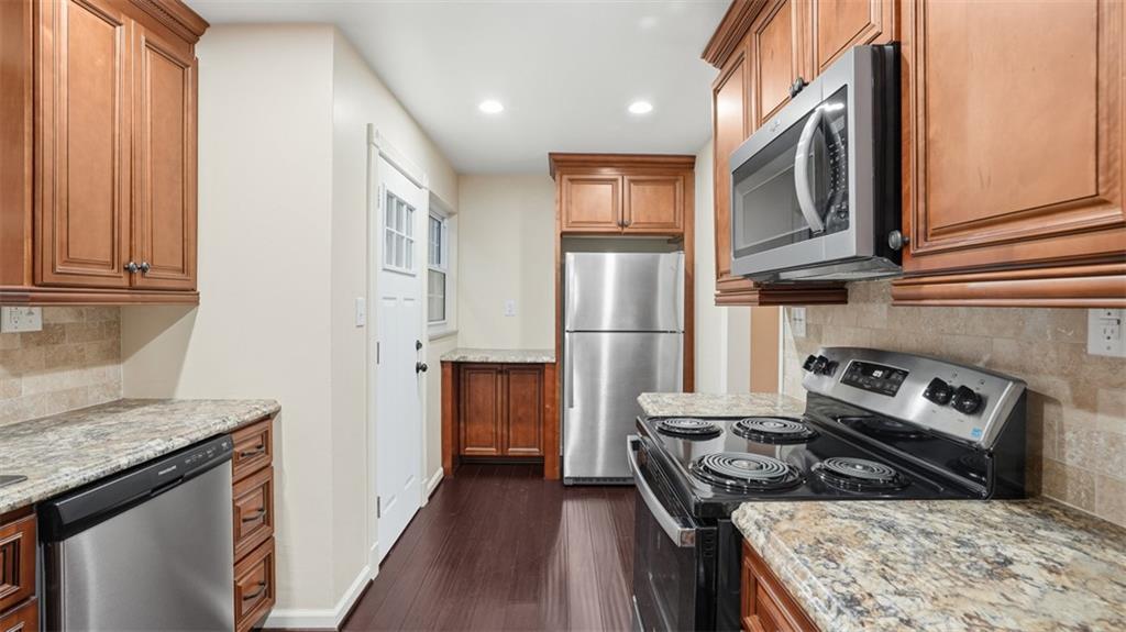 2339 Collins Road Pittsburgh, PA 15235 - Photo 7 of 24 a kitchen with stainless steel appliances granite countertop a stove a refrigerator and a cabinets