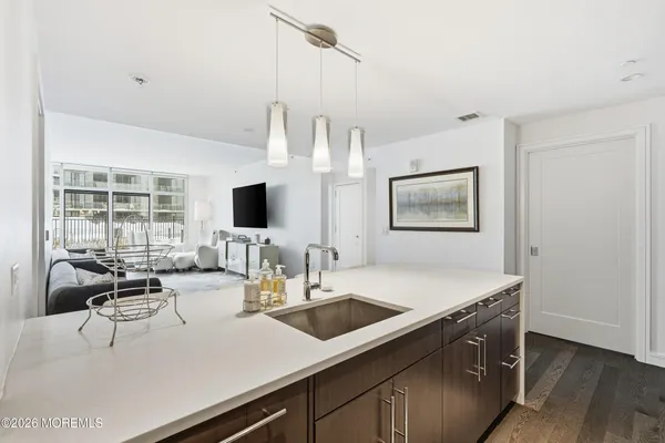 a view kitchen with granite countertop a stove and a sink