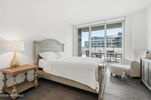 a bedroom with a bed and a large window