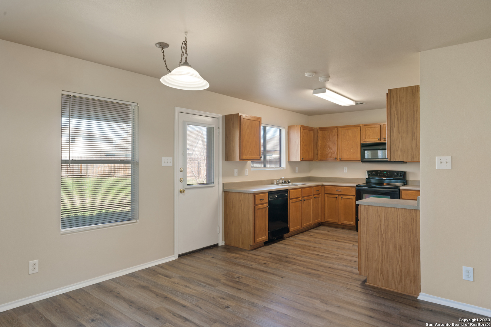 144 Crest Bluff Cibolo, TX 78108 - Photo 14 of 30 a large kitchen with cabinets wooden floor and stainless steel appliances