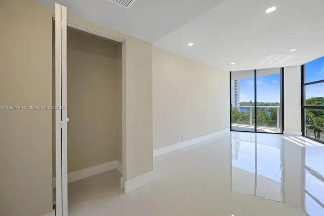 a view of an empty room with glass door