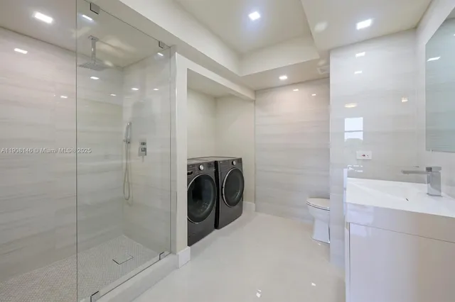 a bathroom with a shower a mirror and a sink