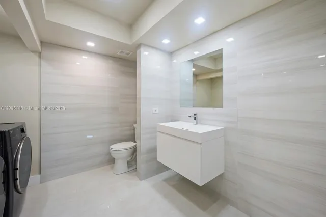 a bathroom with a toilet sink and mirror