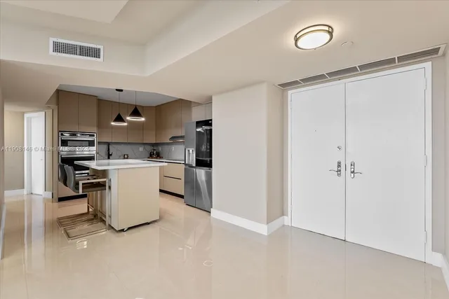 a view of a kitchen with counter top space and appliances