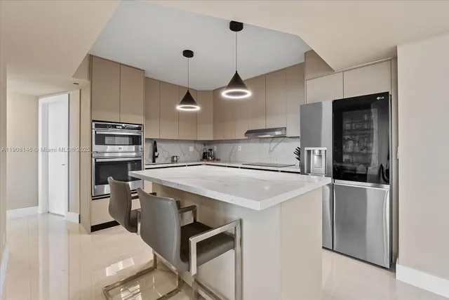 a kitchen with a stove a refrigerator and a sink