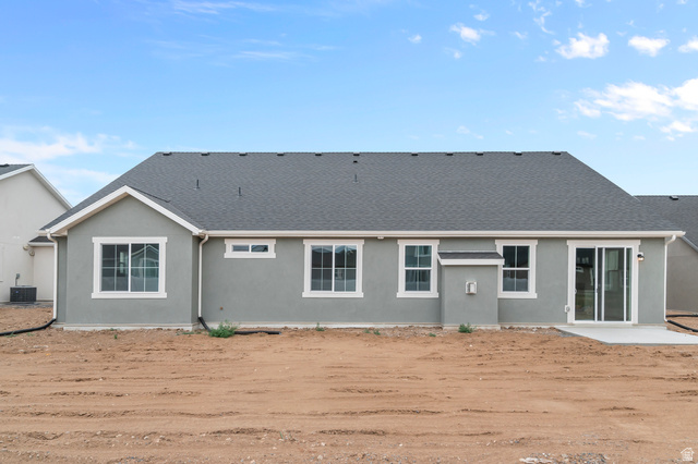 1869 South 2425 West Ogden, UT 84401 - Photo 3 of 22 Rear view of house featuring stucco siding, roof with shingles, and a patio area