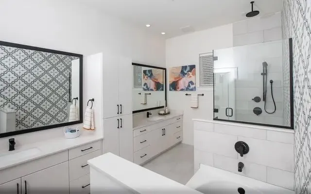 a spacious bathroom with a shower sink and mirror