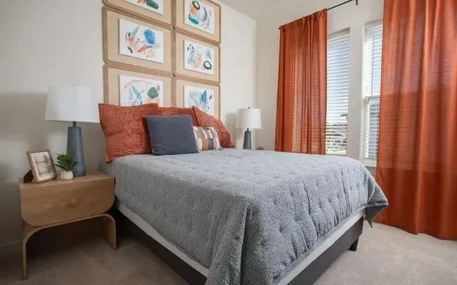 a bedroom with a bed and a painting on the wall