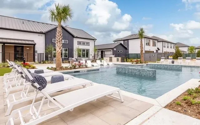 a view of a house with swimming pool and sitting area