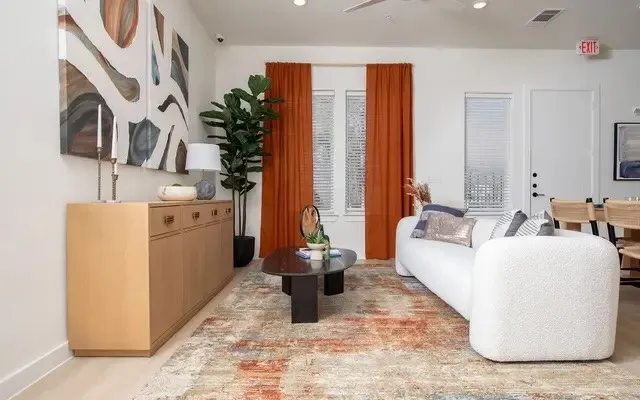 a living room with furniture and large mirror