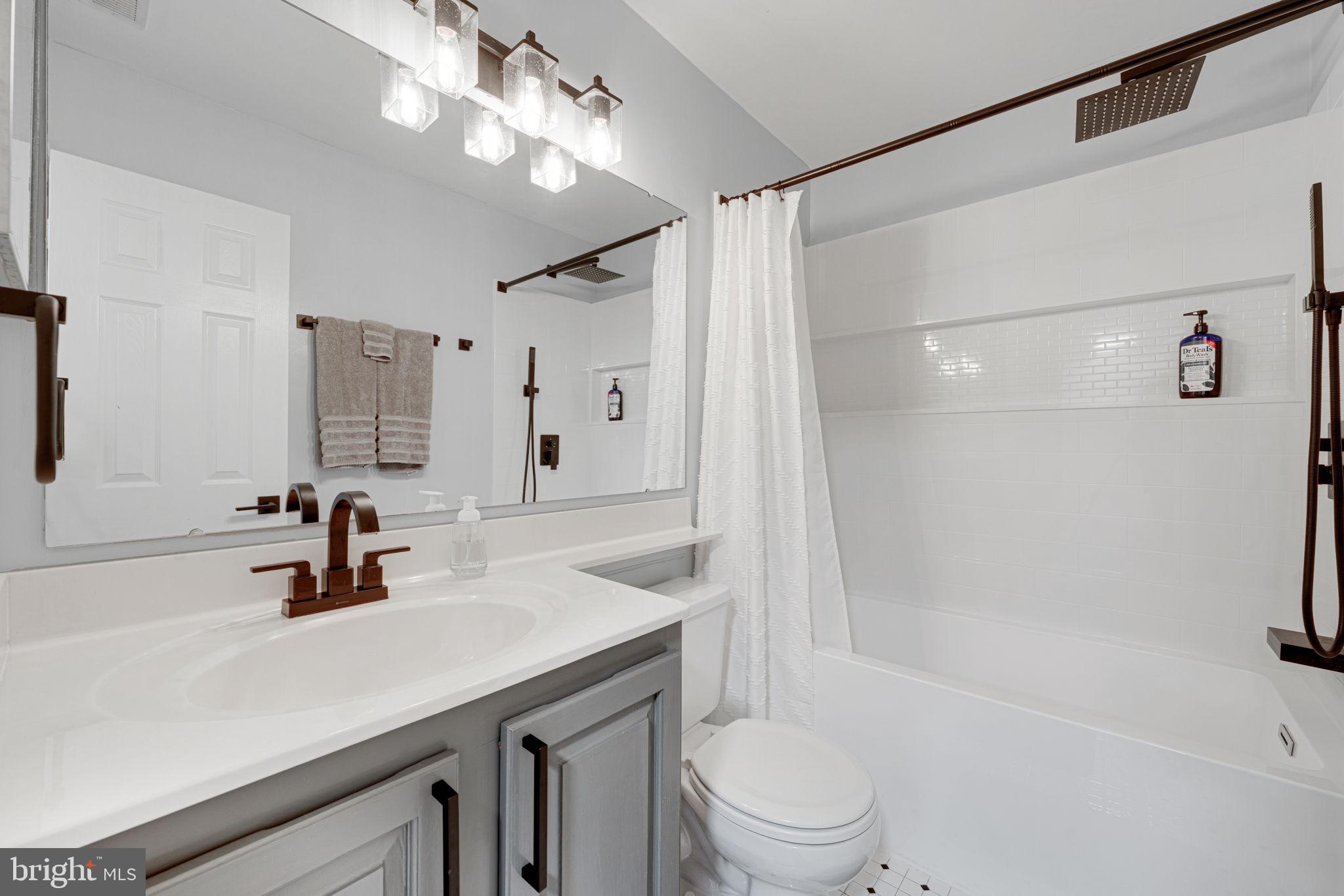 6911 Kerrywood Circle Centreville, VA 20121 - Photo 16 of 44 a bathroom with a sink a toilet a mirror and shower