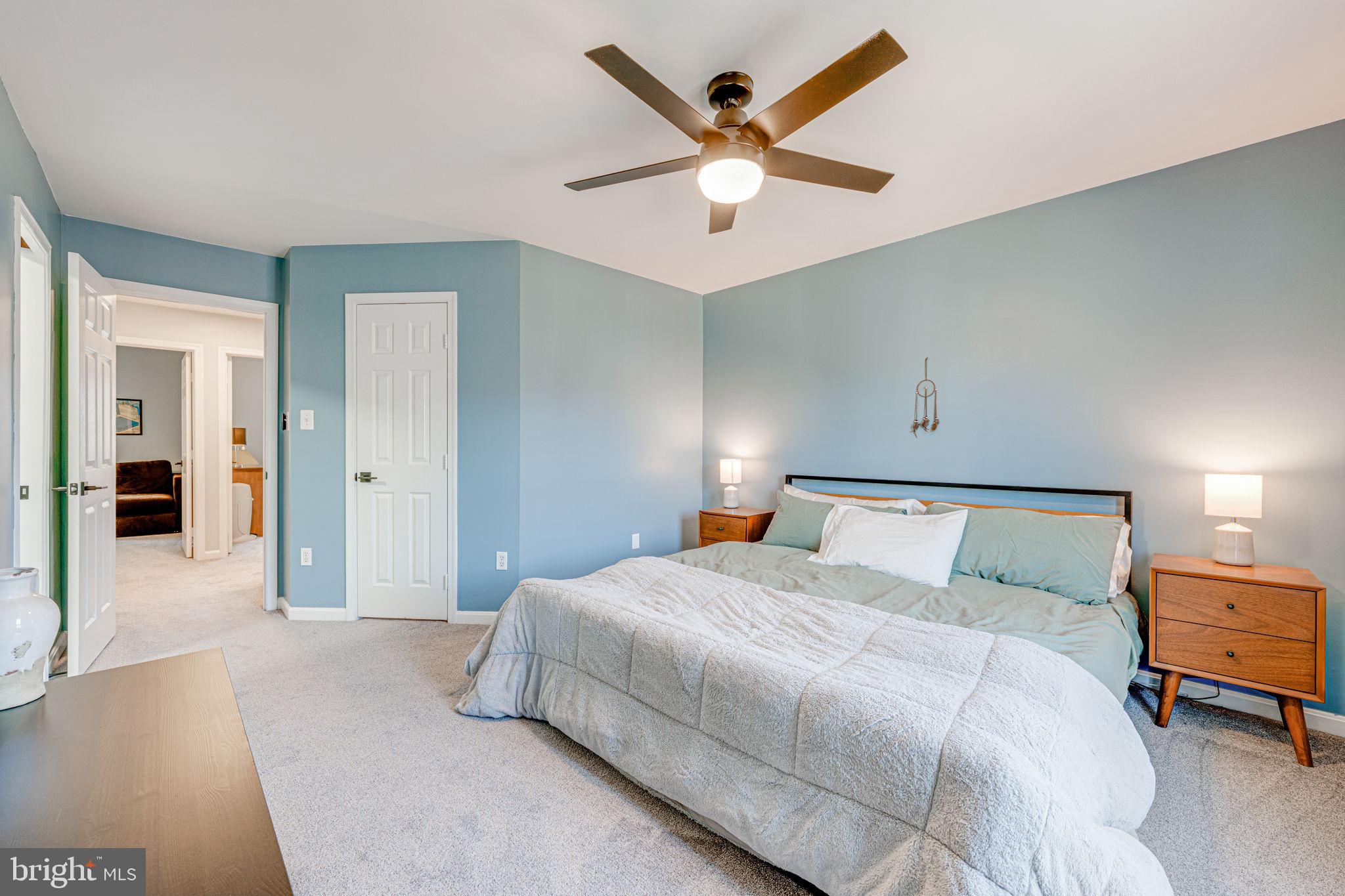 6911 Kerrywood Circle Centreville, VA 20121 - Photo 22 of 44 a bedroom with a large bed and a chandelier