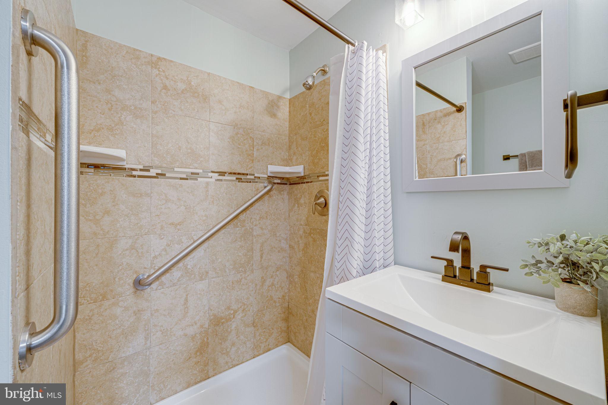 6911 Kerrywood Circle Centreville, VA 20121 - Photo 33 of 44 a bathroom with a sink and a mirror