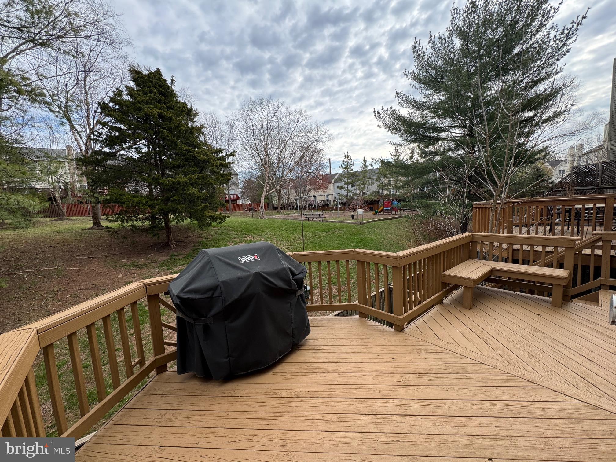 6911 Kerrywood Circle Centreville, VA 20121 - Photo 37 of 44 a view of a wooden deck and a garden