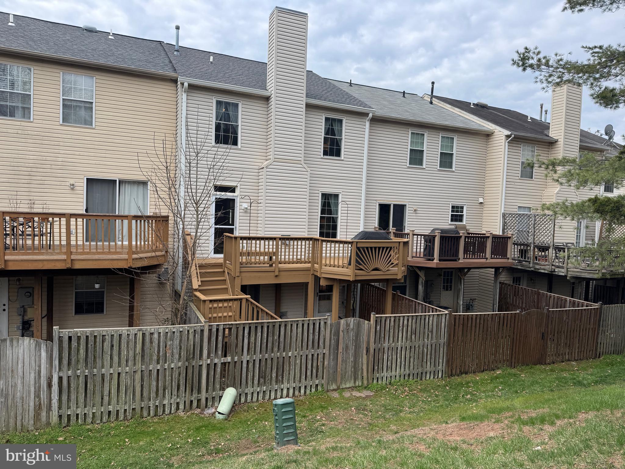 6911 Kerrywood Circle Centreville, VA 20121 - Photo 39 of 44 a view of a house with wooden deck and furniture