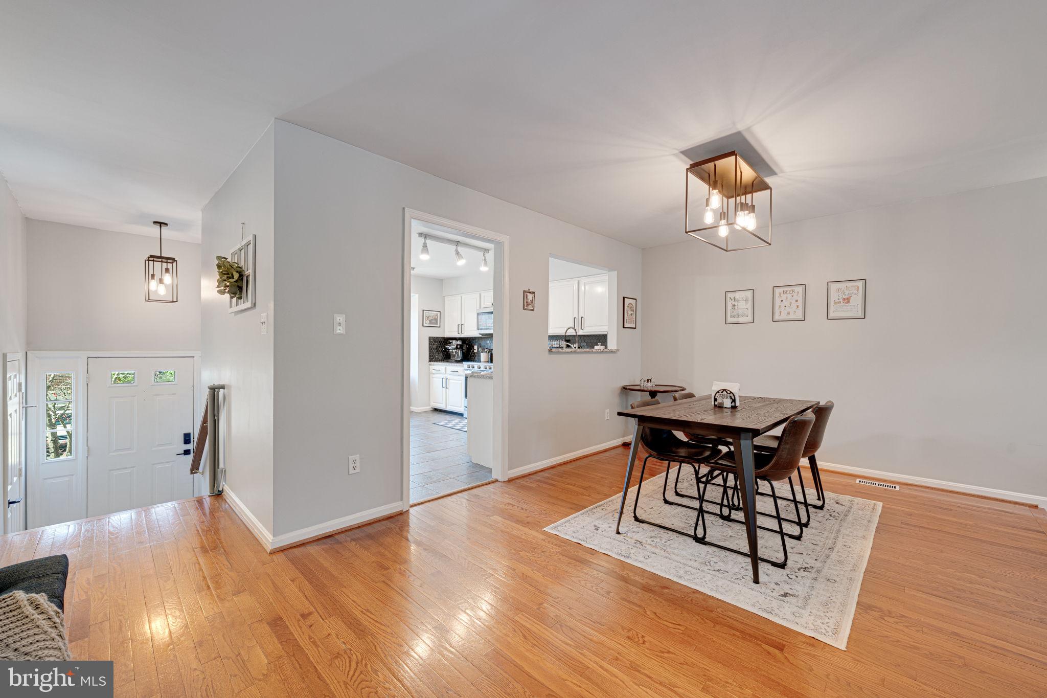 6911 Kerrywood Circle Centreville, VA 20121 - Photo 6 of 44 a view of a dining room with furniture and wooden floor