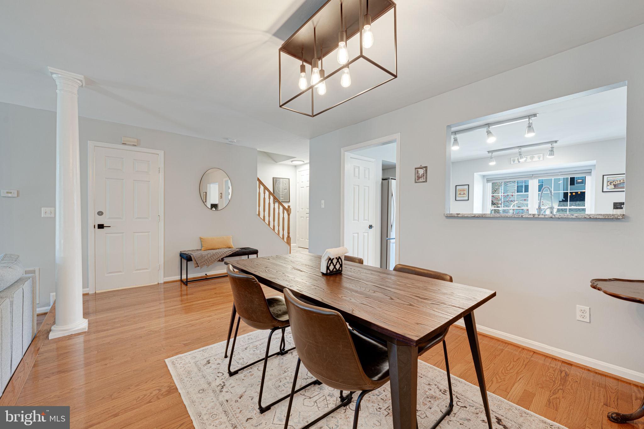 6911 Kerrywood Circle Centreville, VA 20121 - Photo 7 of 44 a view of a dining room with furniture and wooden floor