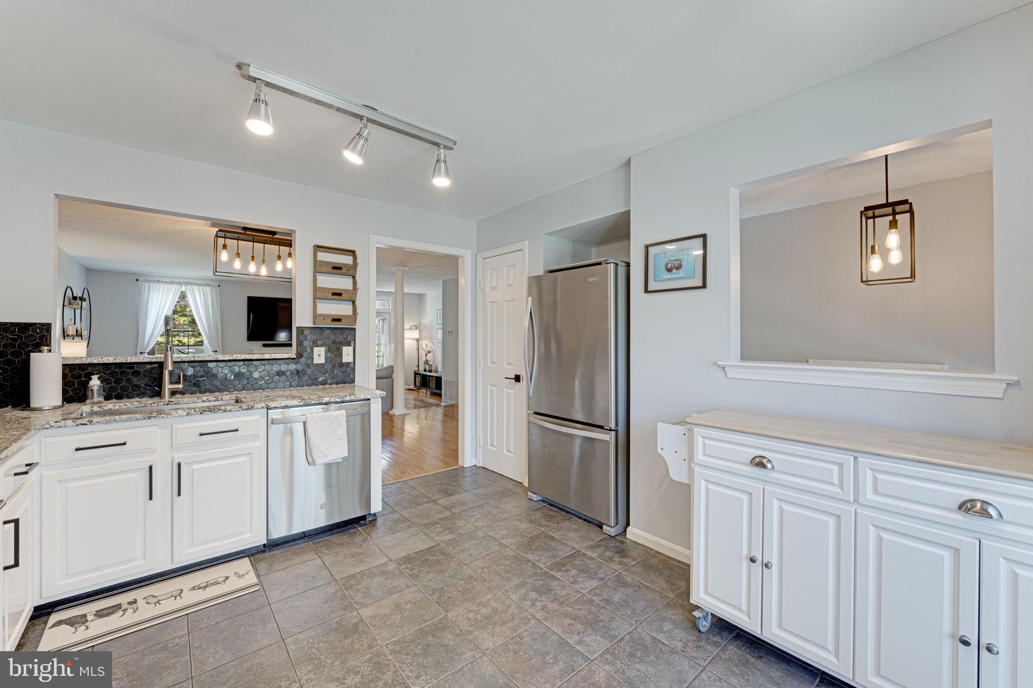6911 Kerrywood Circle Centreville, VA 20121 - Photo 10 of 44 a large white kitchen with cabinets and stainless steel appliances