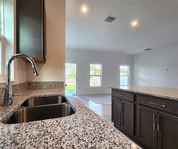 a kitchen with a sink and a stove top oven