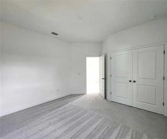 a view of an empty room and wooden floor