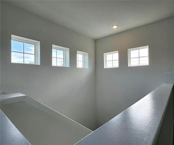 a view of an empty room with windows