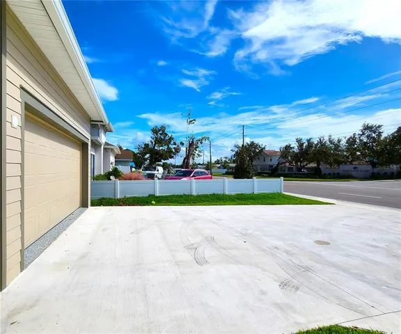 a view of yard with swimming pool and green space