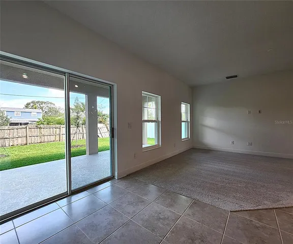 a view of empty room with floor to ceiling window
